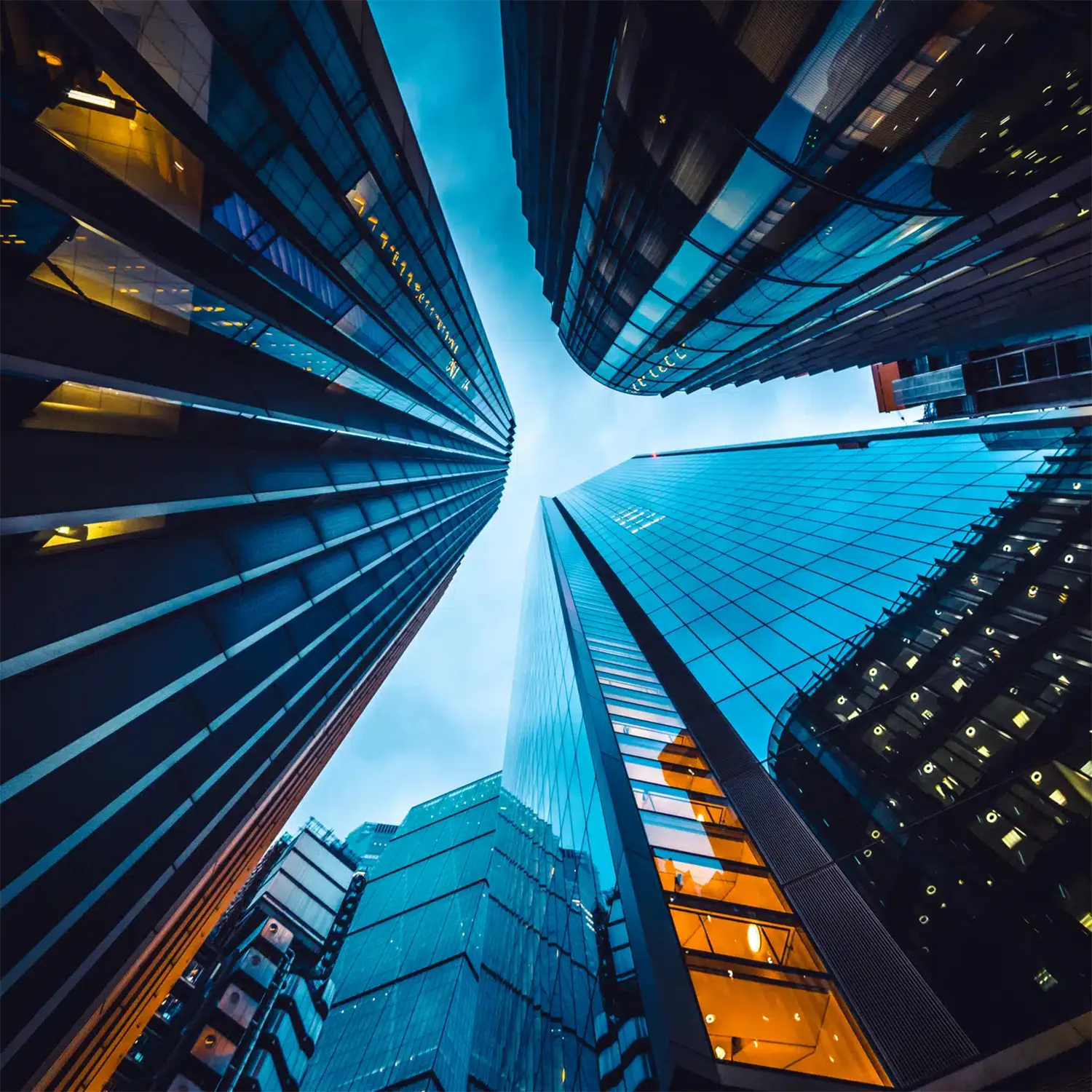 Looking up at skyscrapers forming a tunnel